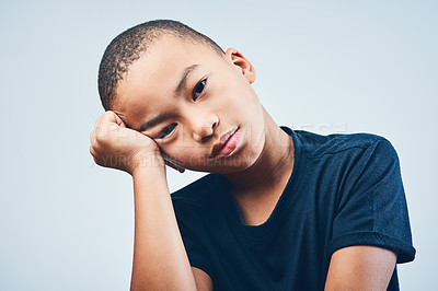 Buy stock photo Studio shot of a cute little boy looking bored against a grey background