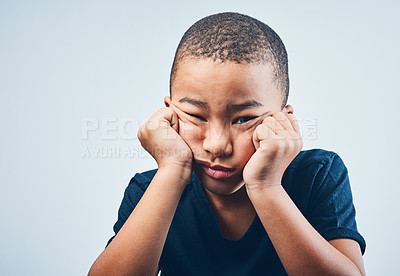 Buy stock photo Portrait, tired and sad with boy, kid and facial expression on gray studio background. Face, childhood and model with emotion, reaction or depression with mental health, boredom or grief with burnout