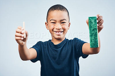 Buy stock photo Studio shot of a cute little boy chalk and a duster against a grey background