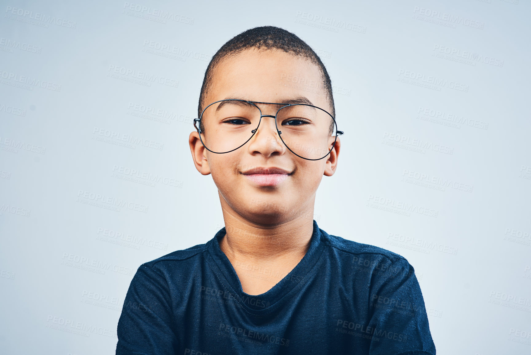 Buy stock photo Studio shot of a cute little boy wearing glasses against a grey background