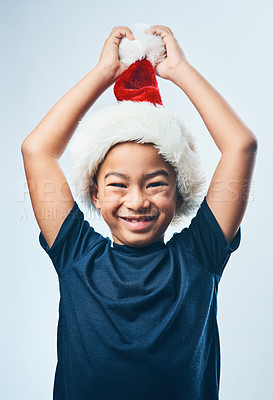 Buy stock photo Christmas, hat and portrait of child in studio excited for holiday, vacation and festive season. Smile, happy and young boy with decoration for tradition, gifts and celebration on white background