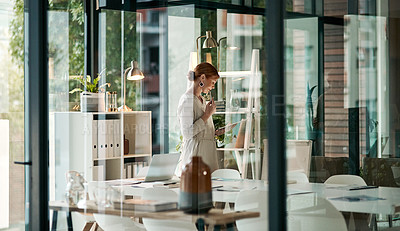 Buy stock photo A modern office, building interior and a businesswoman doing online research on a tablet or looking at files. Female inside her corporate workplace architecture indoors preparing for a presentation.