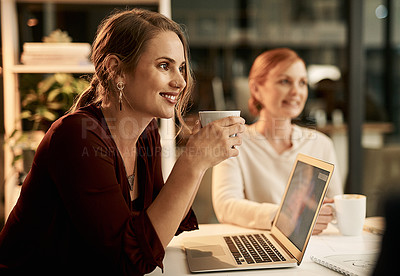 Buy stock photo Young, happy and smiling female students enjoying a cup of coffee in a cafe or restaurant while working late at night. 
Team of university learners doing research for a college project or assignment