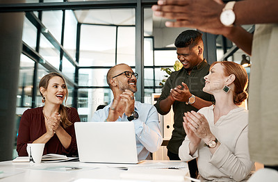 Buy stock photo Excited business people clapping in meeting, celebrating success and cheering for good teamwork while working on a laptop together at work. Colleagues having fun after victory and showing support