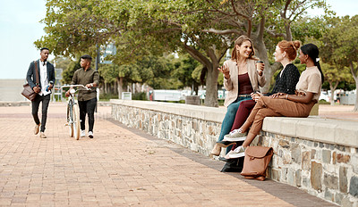 Buy stock photo Shot of a group of young businesswomen chatting during a coffee break in the city