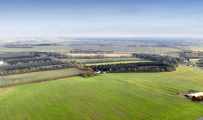 Buy stock photo Landscape aerial view of a farm in the countryside in summer. Agricultural field for farming, cultivation, and harvesting from above. An empty piece of land for vineyards, ranching, and growing crop