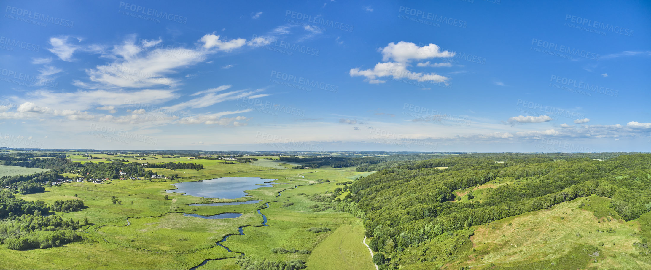 Buy stock photo Landscape aerial view of an empty farm in the harvest in summer in Denmark. Secluded and remote land for growing crop against a blue cloudy sky in the morning. Agricultural fields in the countryside
