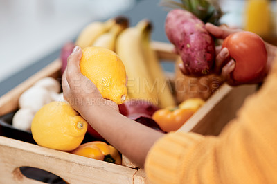 Buy stock photo Cropped shot of a woman unpacking her groceries in the kitchen at home