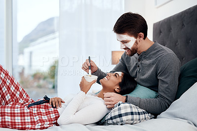 Buy stock photo Shot of a young couple getting homemade facials together at home