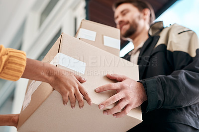 Buy stock photo Shot of a young man delivery a package to a woman at home