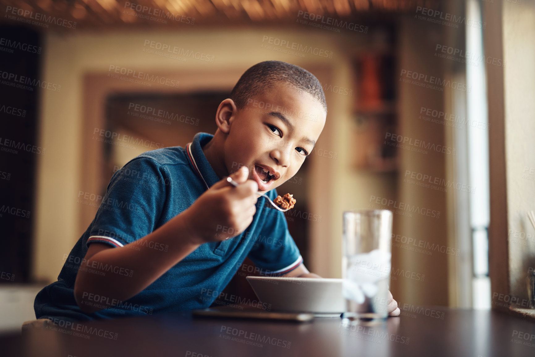 Buy stock photo Cropped shot of a young boy eating a bowl of spaghetti at home