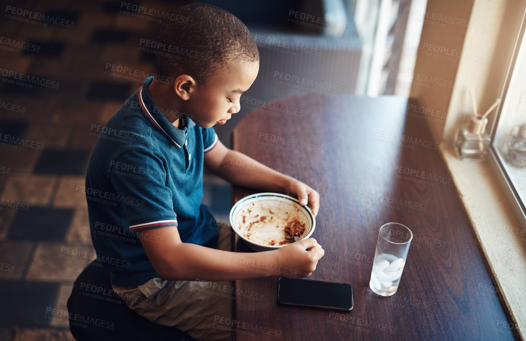Buy stock photo Shot of a young boy eating a bowl of spaghetti at home
