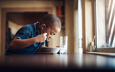 Buy stock photo Child, boy and eating food in kitchen for nutrition, hungry and healthy development in home. African kid, pasta or spaghetti meal in house for lunch, dinner and cuisine with water at dining table