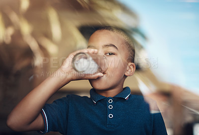 Buy stock photo Cropped shot of a young boy drinking a glass of water at home