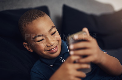 Buy stock photo Boy, bedroom and positive with smartphone for video games, entertainment and subscription at home. African person, kid and happiness in bed on internet or online with streaming for child development