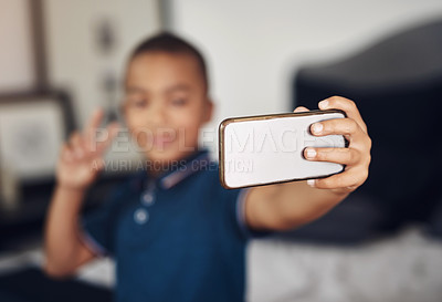 Buy stock photo Cropped shot of a young boy taking a selfie at home