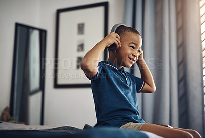 Buy stock photo Boy, bedroom and happy with headphones for streaming music, audio and radio for fun. African person, bed and kid with smile at home for subscription, online and website for playlist and album