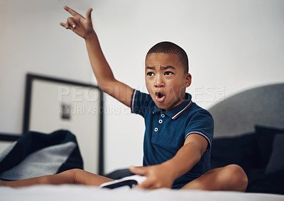 Buy stock photo Shot of a young boy playing video games at home