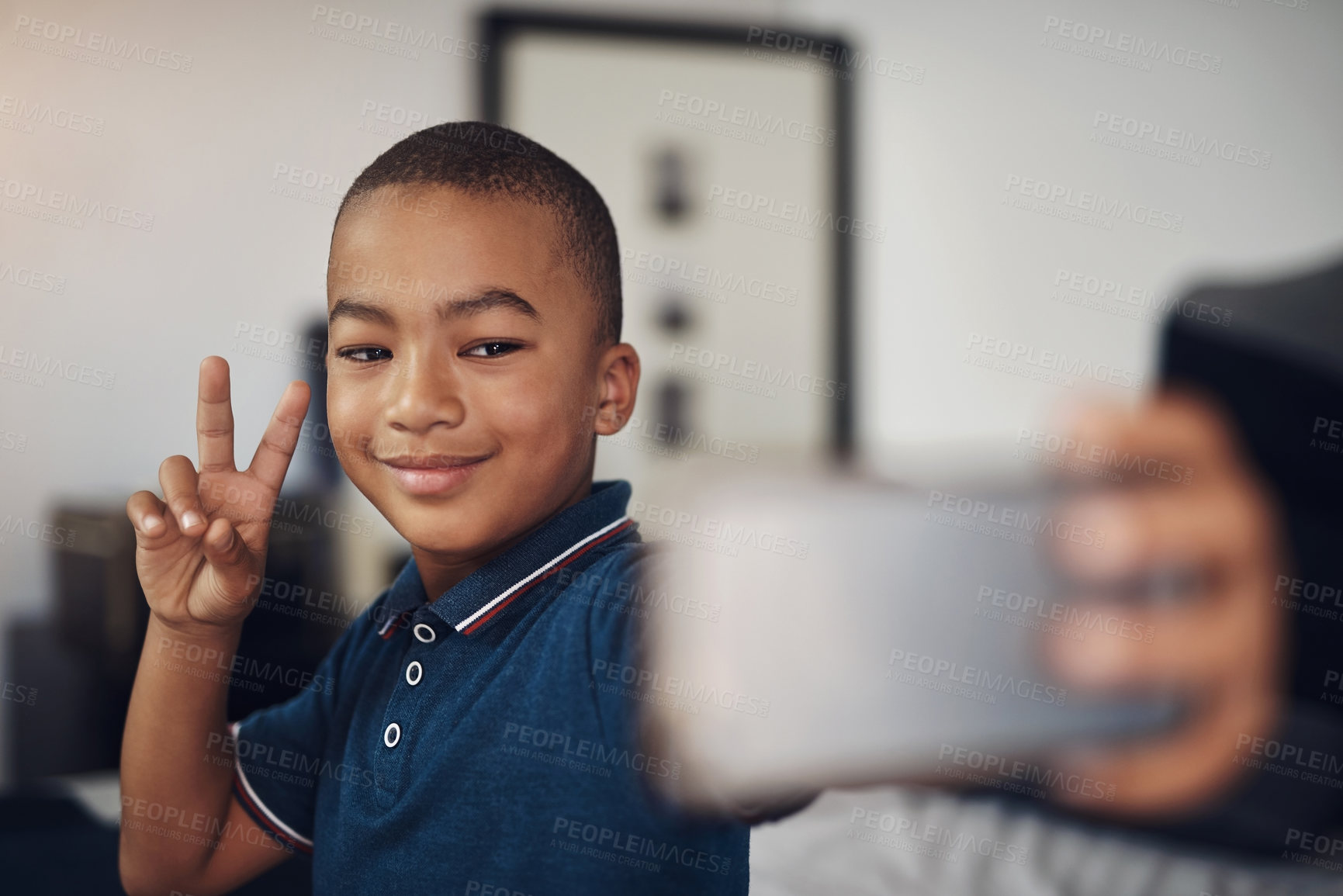 Buy stock photo Cropped shot of a young boy taking a selfie at home