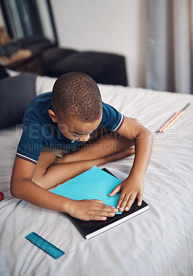 Buy stock photo Child, learning and home with paper plane for education, project or fun creative activity. Kid, little boy or youth with craft or invention for assignment, creation or homework in bedroom at house