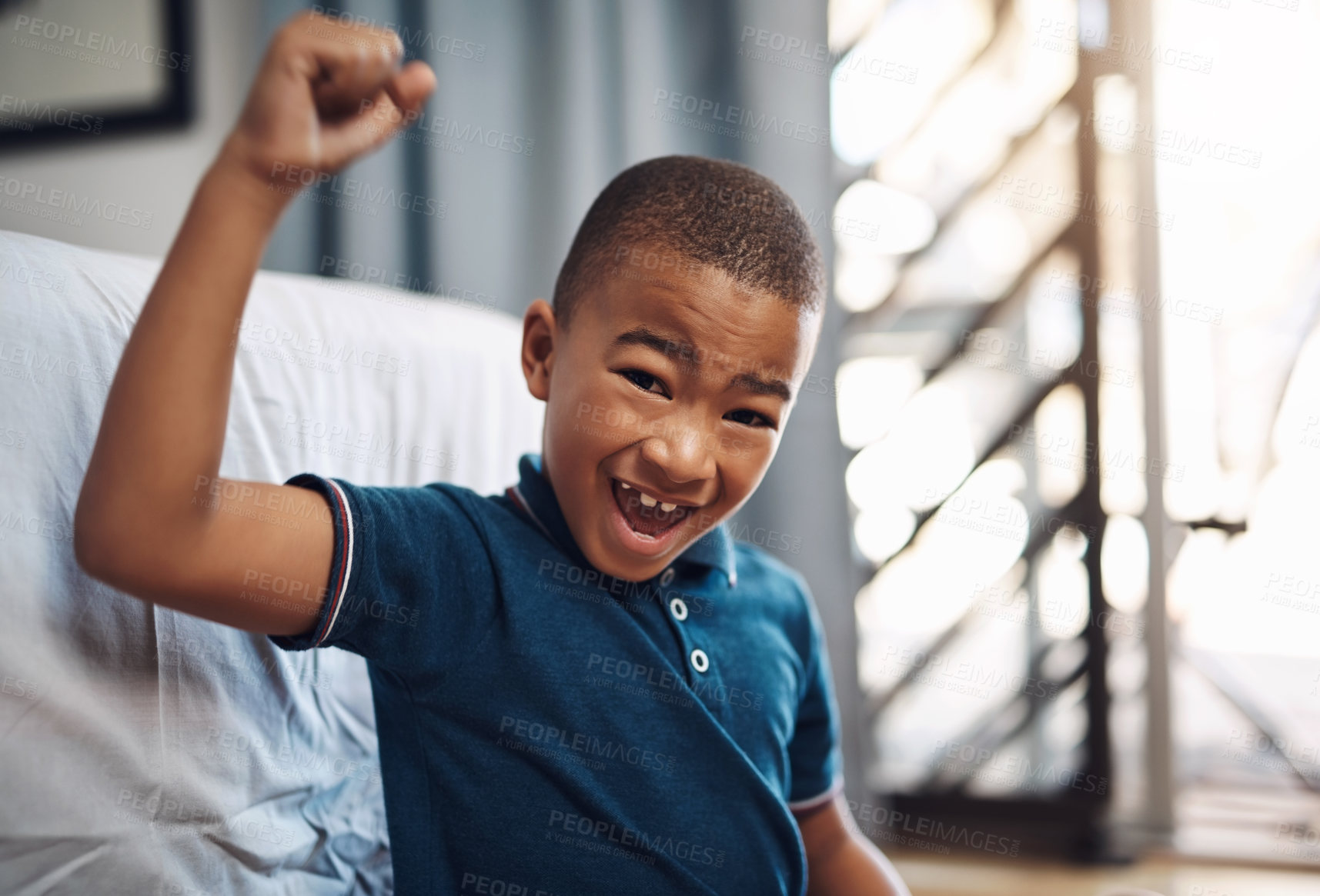 Buy stock photo Excited, winning and portrait of child in home with smile, fun and weekend achievement in bedroom. Relax, face and boy on floor at bed with celebration, hands up and morning happiness in apartment.