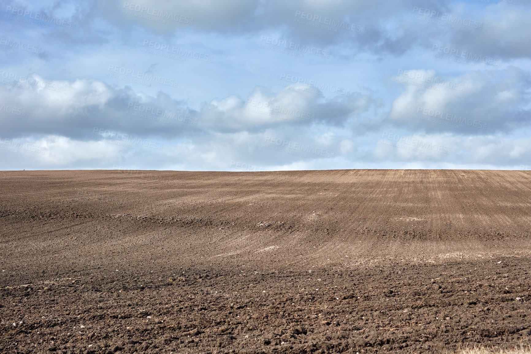 Buy stock photo Cloudy, field and arid landscape for agriculture, autumn weather and environmental crisis for barren land. Countryside, dry season or farmland with drought for sustainability problem, space or nature