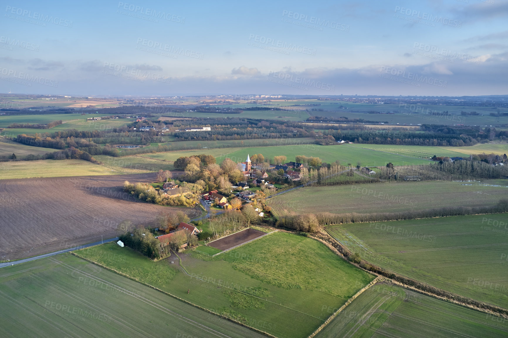 Buy stock photo Drone point of view of private farming estate growing rye, wheat and sunflowers in remote farms and fields in Jutland, Denmark. Scenic aerial landscape of agriculture in green and serene countryside 