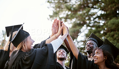 Buy stock photo Shot of a group of students giving each other a high five on graduation day