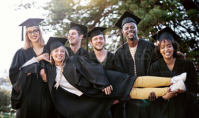 Buy stock photo Portrait of a group of students holding one of their peers on graduation day