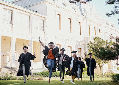 Buy stock photo Shot of a group of students running together in a row on graduation day