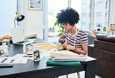 Buy stock photo Cropped shot of a young designer cutting out patterns at home