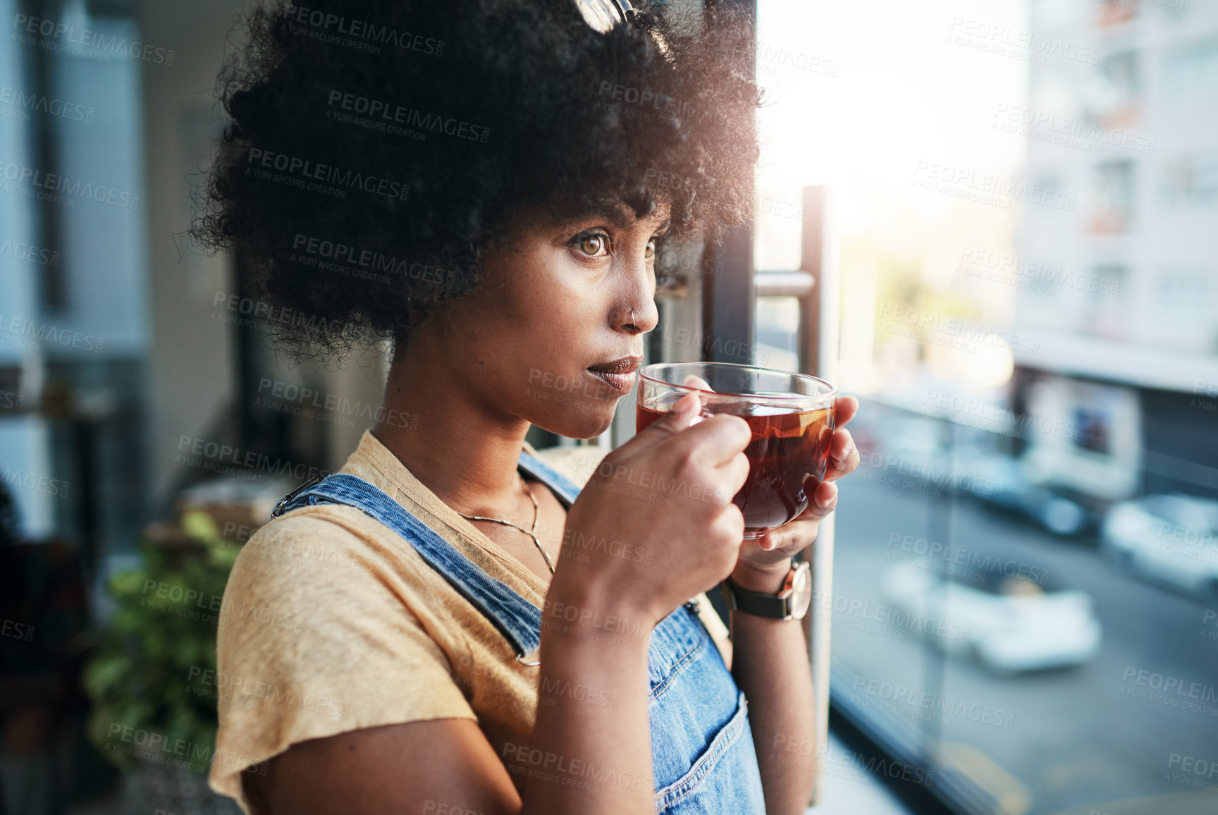 Buy stock photo Black woman, tea or thinking with glass by window for vision, ambition or dream in city at home. Young African, female person or freelancer with beverage in wonder or contemplating for ideas at house