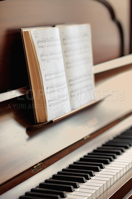 Buy stock photo Closeup of a vintage piano and keyboard with a sheet music book. An empty antique or wooden musical instrument for playing classical jazz or used for old traditional songwriting and rehearsals
