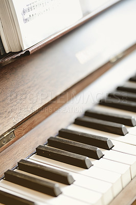 Buy stock photo Closeup of a vintage piano and keyboard with sheet music book. Antique and classic musical instrument for a talented musician to play or compose songs and a melody during a performance concert