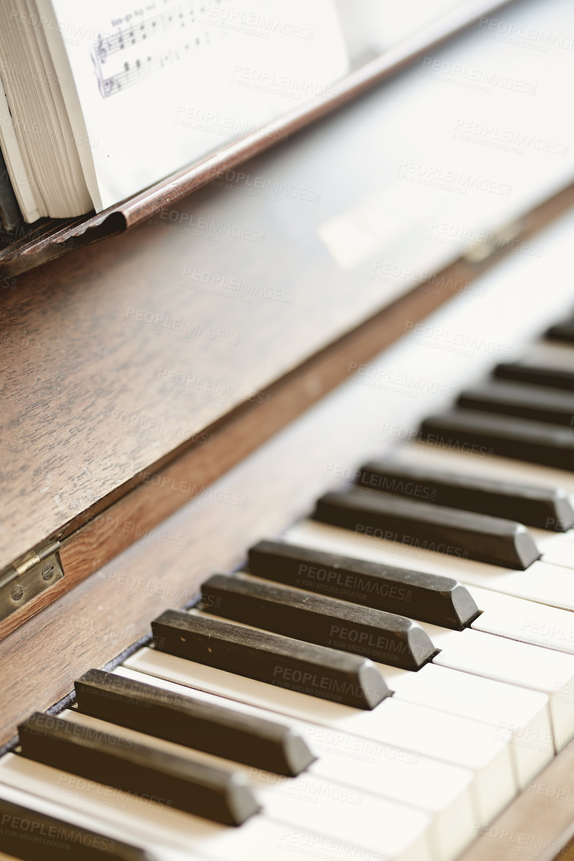 Buy stock photo Closeup of a vintage piano and keyboard with sheet music book. Antique and classic musical instrument for a talented musician to play or compose songs and a melody during a performance concert