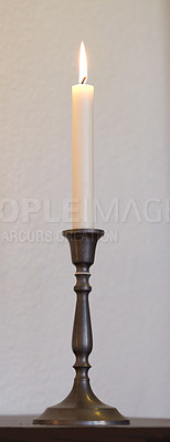 Buy stock photo One lit candle on a table at home for decoration and warmth. Beautiful house decor used for aroma, good scent and to bring light a room.