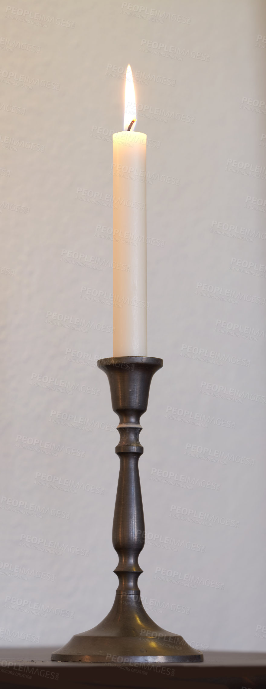 Buy stock photo One lit candle on a table at home for decoration and warmth. Beautiful house decor used for aroma, good scent and to bring light a room.