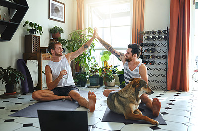 Buy stock photo Shot of two men giving each other a high five after their yoga workout at home
