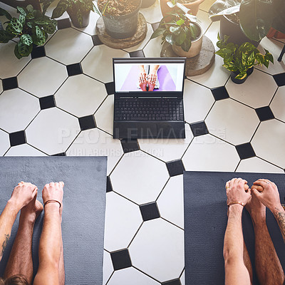 Buy stock photo Shot of two men using a laptop while going through a yoga routine at home