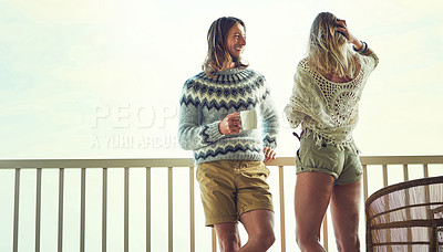 Buy stock photo Shot of a young couple relaxing on their balcony