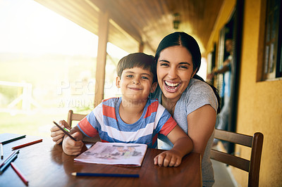 Buy stock photo Cropped shot of a young beautiful mother colouring in pictures with her adorable son at home