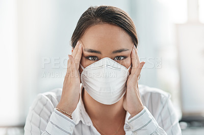 Buy stock photo Shot of a masked young businesswoman looking stressed while working in a modern office