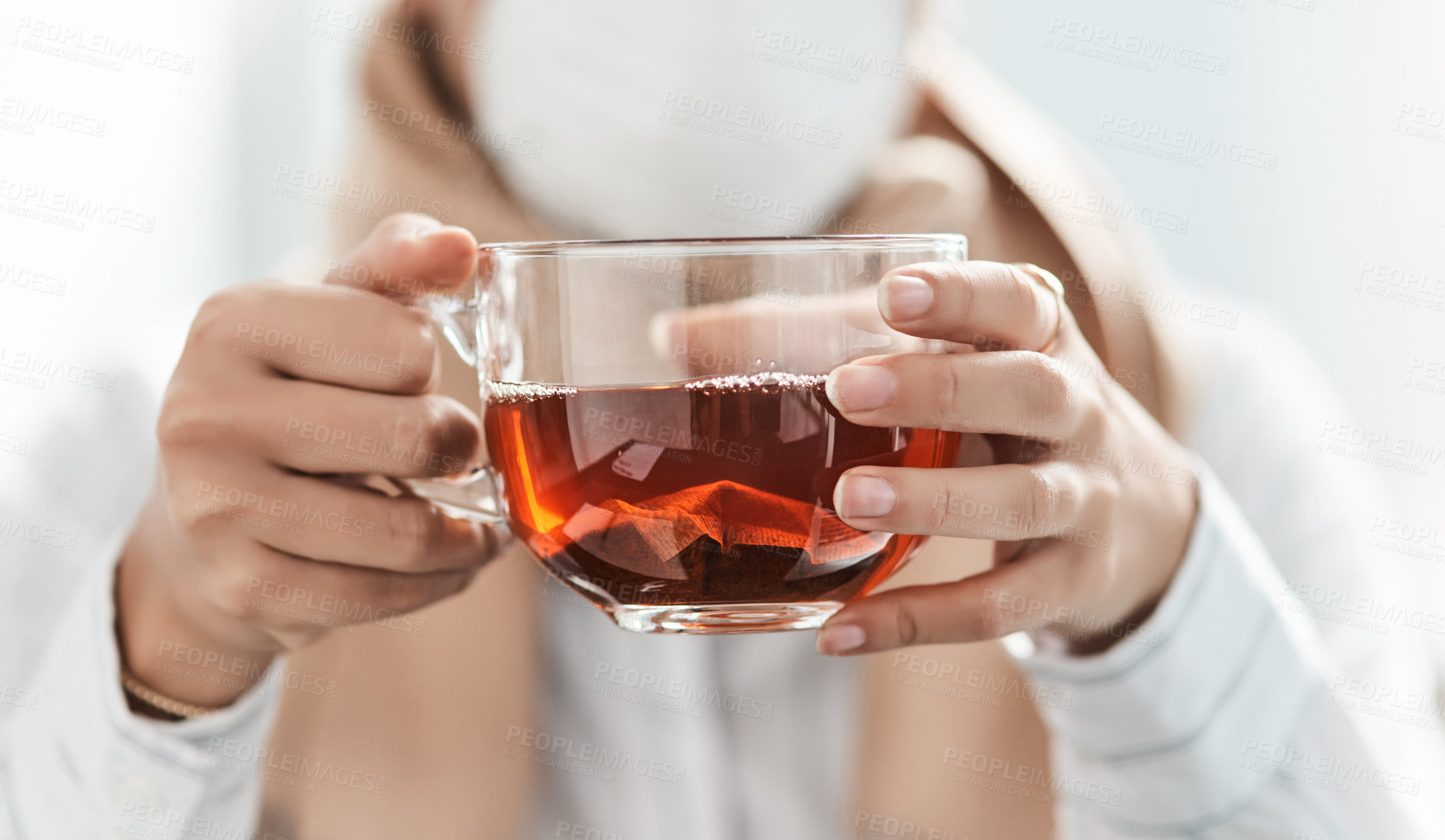 Buy stock photo Cropped shot of a businesswoman having a glass of herbal tea in a modern office