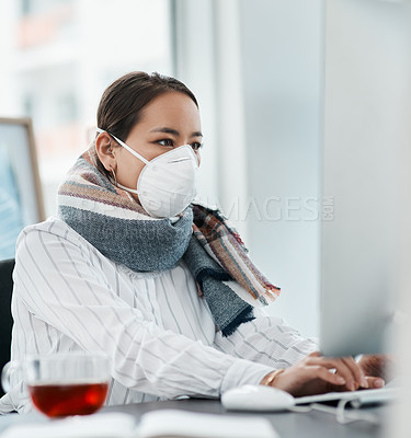 Buy stock photo Shot of a masked young businesswoman using a computer in a modern office