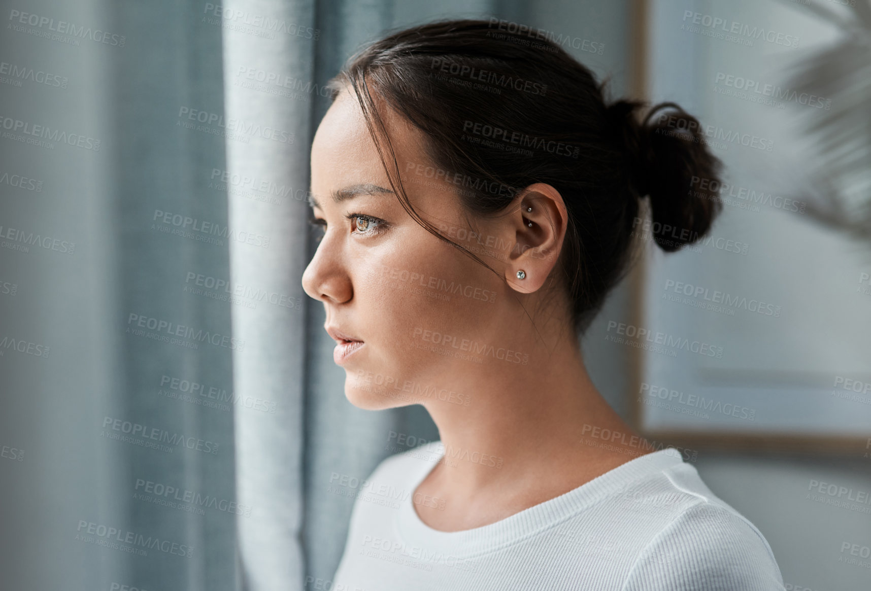 Buy stock photo Cropped shot of a beautiful woman looking out the window at home