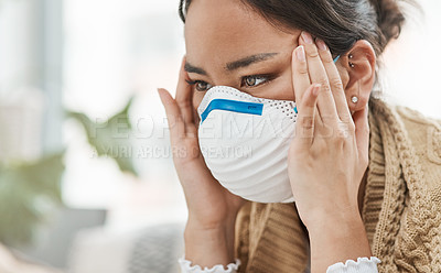 Buy stock photo Cropped shot of a woman wearing a mask while looking stressed at home