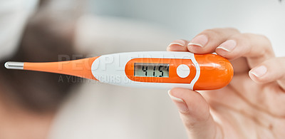 Buy stock photo Shot of a woman holding up a digital thermometer that reads 41.5 degrees