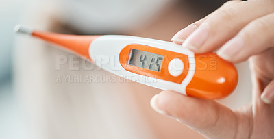 Buy stock photo Shot of a woman holding up a digital thermometer that reads 41.5 degrees