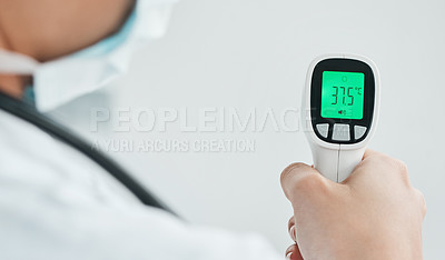 Buy stock photo Cropped shot of a medical practitioner holding a infrared thermometer