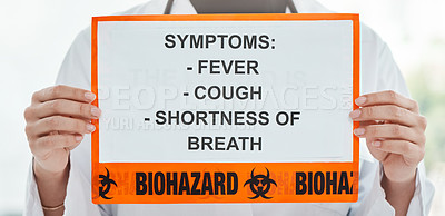 Buy stock photo Cropped shot of a doctor holding a sign with a list of COVID-19 symptoms on it